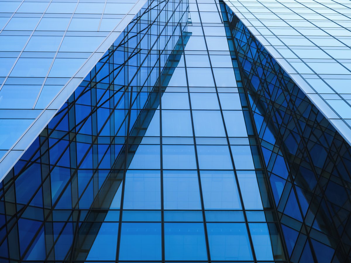 Modern building exterior Blue Glass facade Low angle view Architecture details Business background